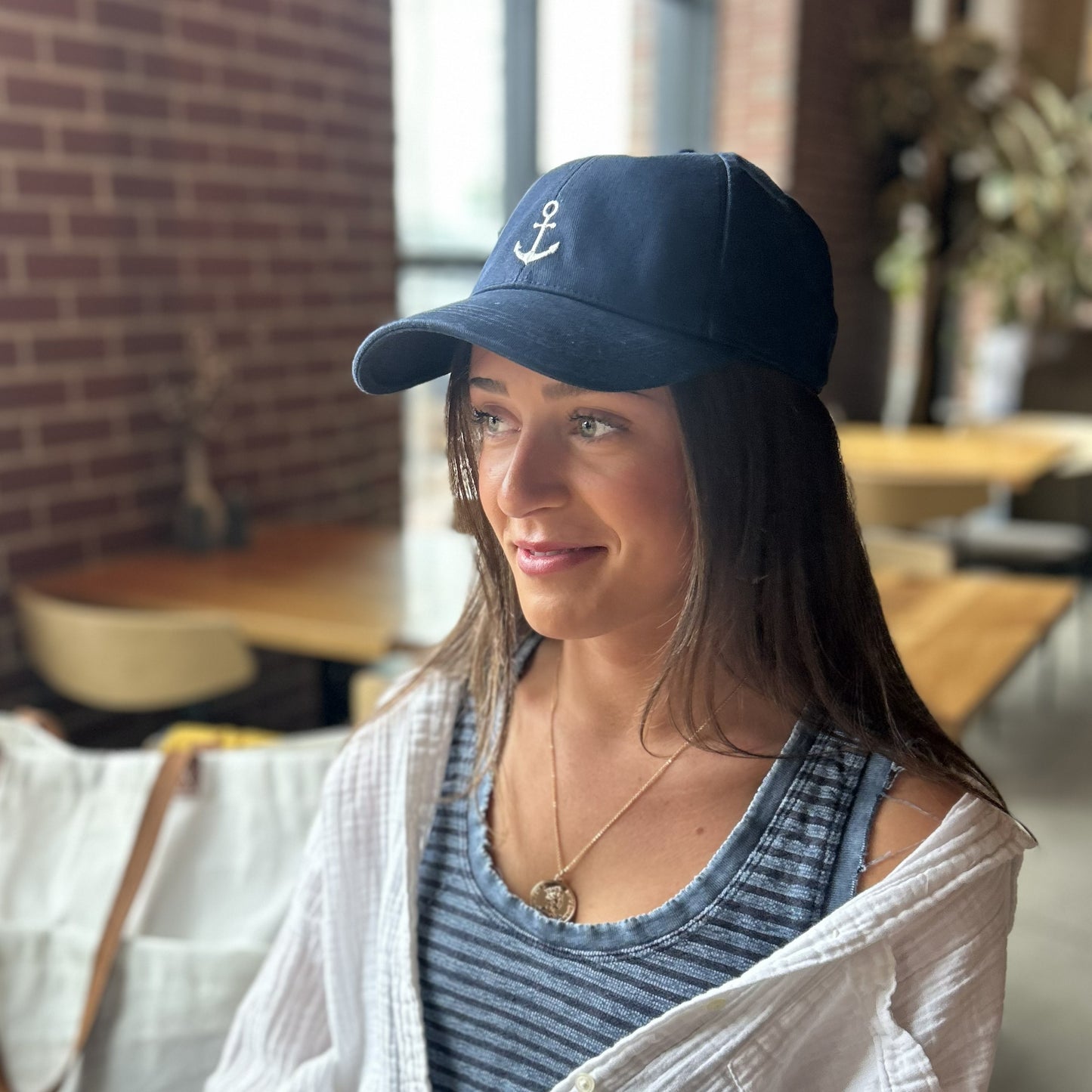 anchor baseball cap navy blue shown on a person in a portland maine coffee shop at canopy hotel