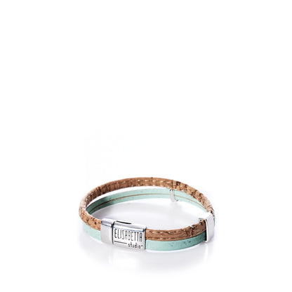 A Portuguese cork bracelet in mint green with a sea turtle charm and a silver magnetic clasp engraved Elisabetta Studio, displayed on a white background. by Sea Bags