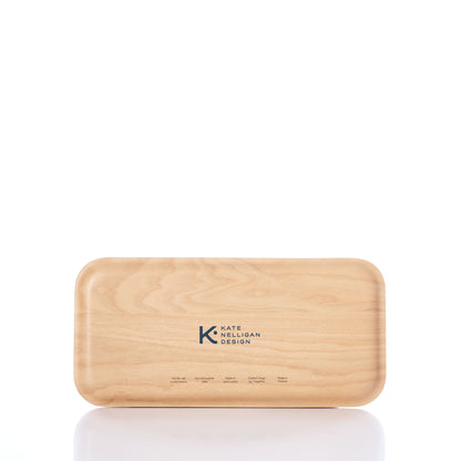 A rectangular wooden box, the Kate Nelligan Full Sail Tray by Trays4Us, crafted from Scandinavian birch with rounded edges and Kate Nelligan Design printed on the lid, is shown against a white background. by Sea Bags