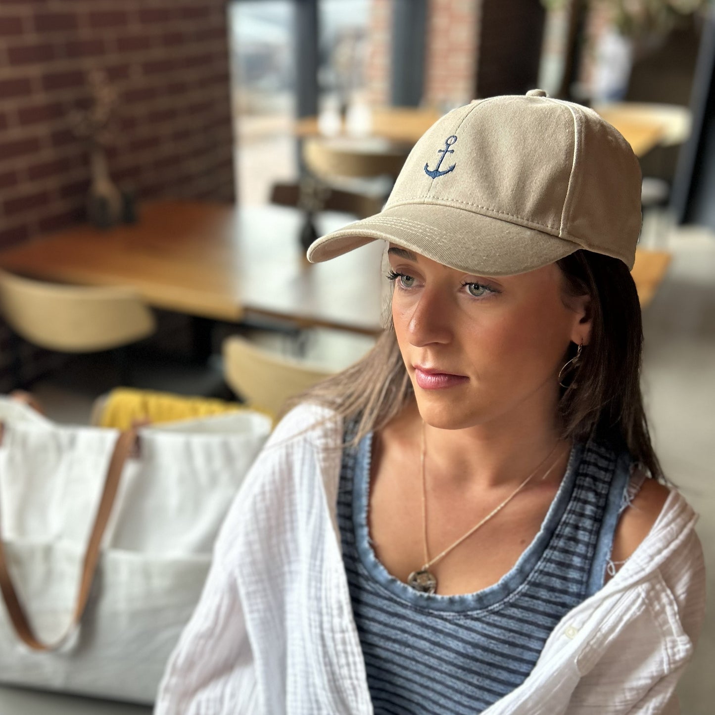 anchor baseball cap beige shown on a person in a portland maine coffee shop at canopy hotel