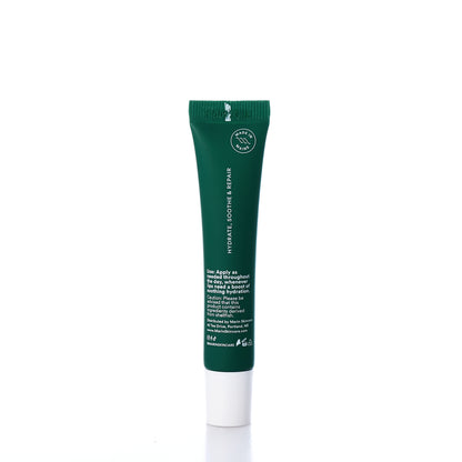 A green tube of Marin Skincares Marin Lip Treatment - Mint, infused with Marine Glycoproteins and featuring white text instructions, is shown standing upright on a white background. by Sea Bags