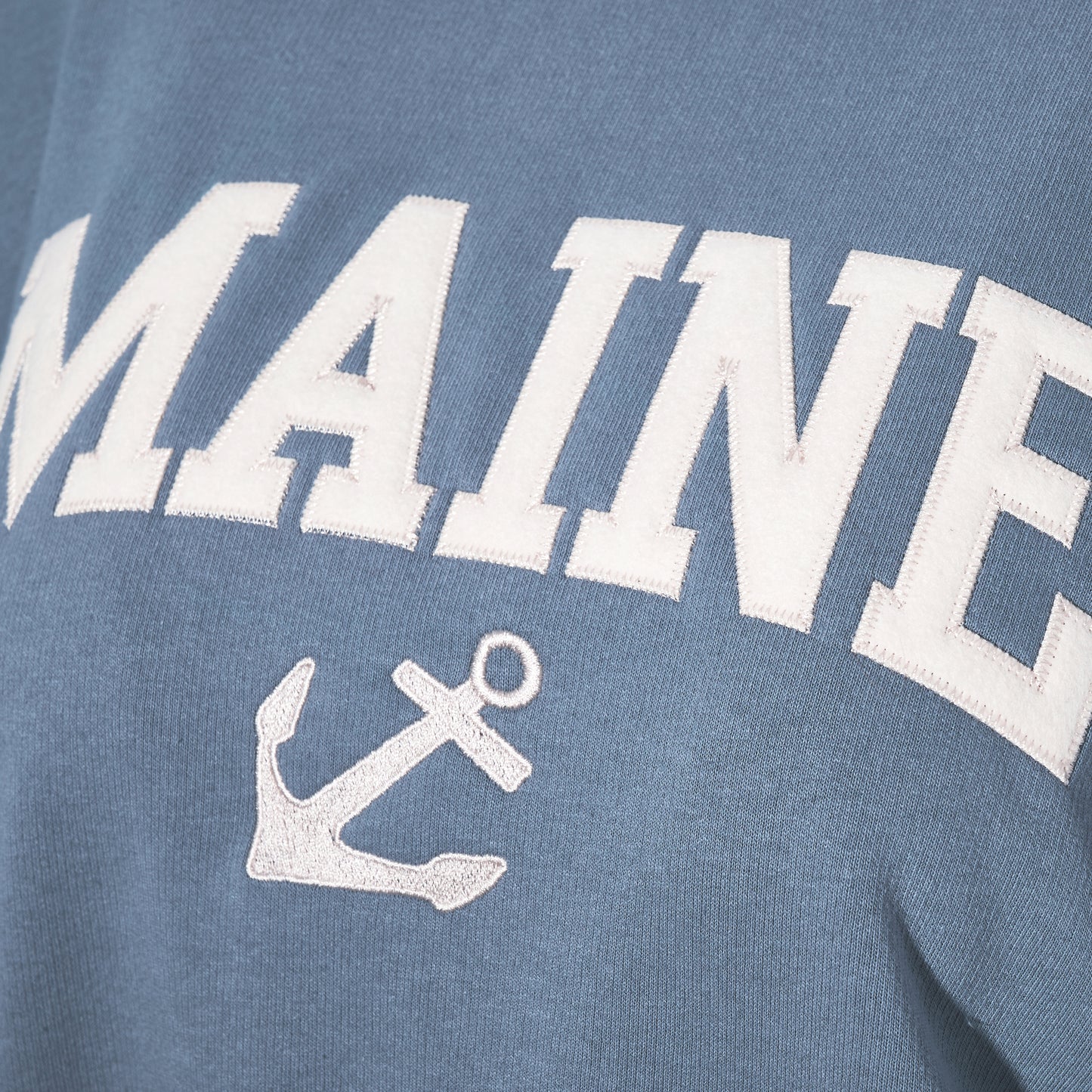 Blue sweatshirt with 'MAINE' and an anchor design on a blue background