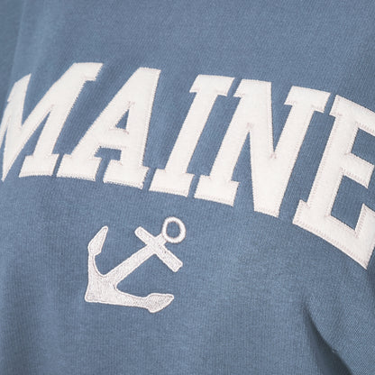 Show off your Maine coastal style with the Soft As A Grape Crewneck Pullover - Denim Maine Anchor, featuring bold white MAINE lettering and a classic anchor graphic on a denim-blue crewneck. by Sea Bags
