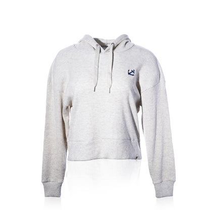 The Ribbed Hoodie Pullover - Oatmeal Anchor by Soft As A Grape features a light oatmeal ribbed texture, drawstrings, and a small navy anchor logo on the left chest. Displayed on a plain white background, this coastal style pullover offers a relaxed yet refined look that’s perfect for layering throughout the year. by Sea Bags
