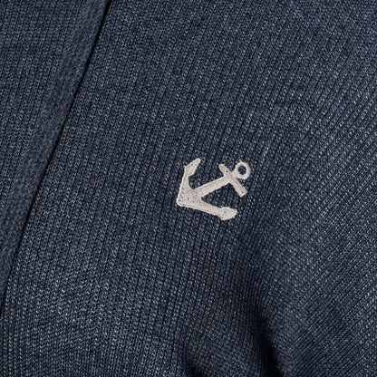 Close-up of the Soft As A Grape Ribbed Hoodie Pullover - Navy Anchor, showcasing its navy blue ribbed fabric and a small white embroidered anchor, perfect for bringing a subtle coastal style to your look. by Sea Bags