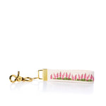 Keychain with pink floral design on a white background