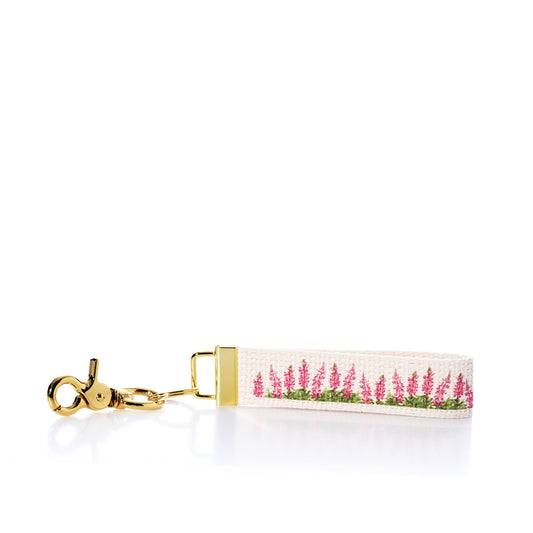 Keychain with pink floral design on a white background