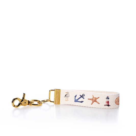 Keychain with nautical-themed design on a white background