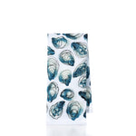 White towel with blue oyster shell pattern on a white background