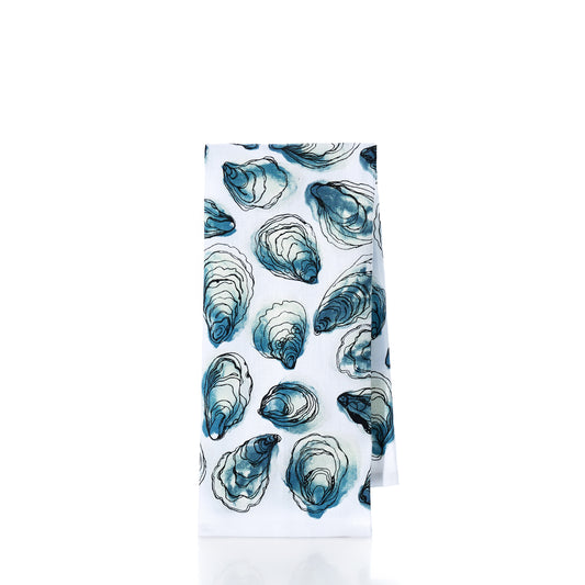 White towel with blue oyster shell pattern on a white background