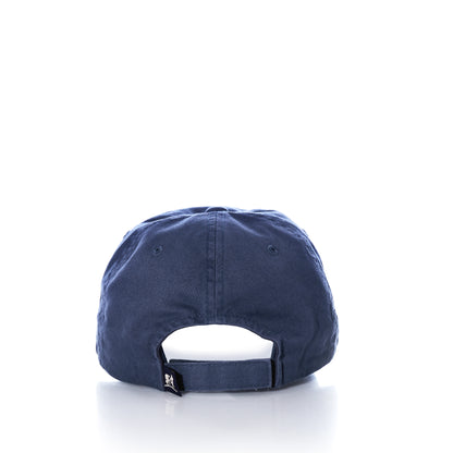 Back view of the Belted Cow Lobster Hat, a navy blue cotton baseball cap featuring an adjustable strap and a small branded tab, inspired by coastal style, displayed against a white background.