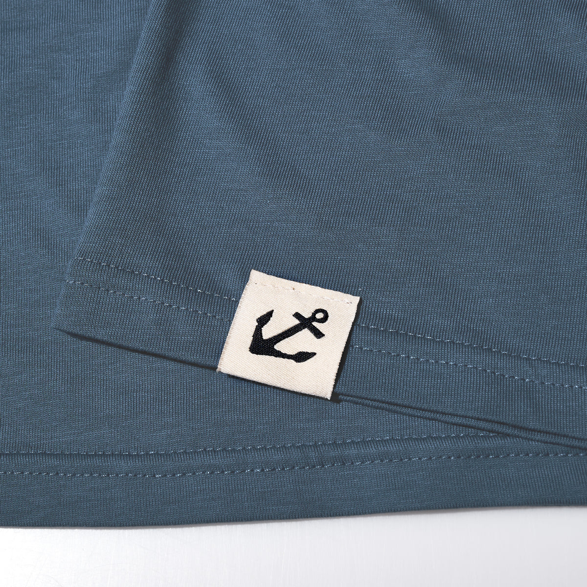 The Sea Bags 06 Octopus T-Shirt by 320Ink d/b/a Riptide Print Company features blue 100 cotton with a sewn white tag and black anchor logo near the hem.
