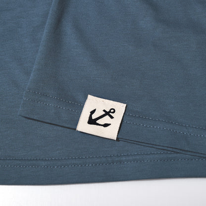 The Sea Bags 06 Octopus T-Shirt by 320Ink d/b/a Riptide Print Company features blue 100 cotton with a sewn white tag and black anchor logo near the hem.