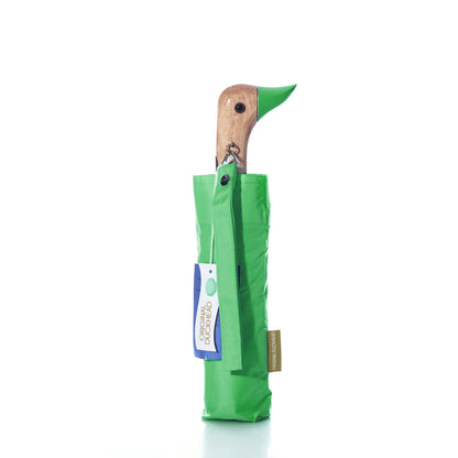A compact, matcha green wind-resistant Original Duck Head Umbrella - Matcha Green with a wooden handle shaped like a duck head.