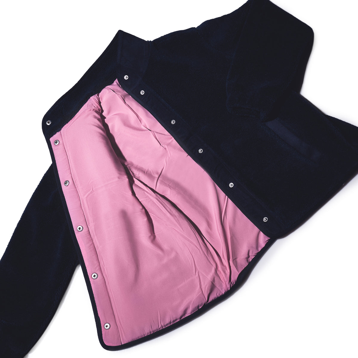The Fleece Button-Front Coat - Navy by Batela USA Inc features a dark exterior, light pink lining, and metal buttons—perfect for breezy coastal adventures.