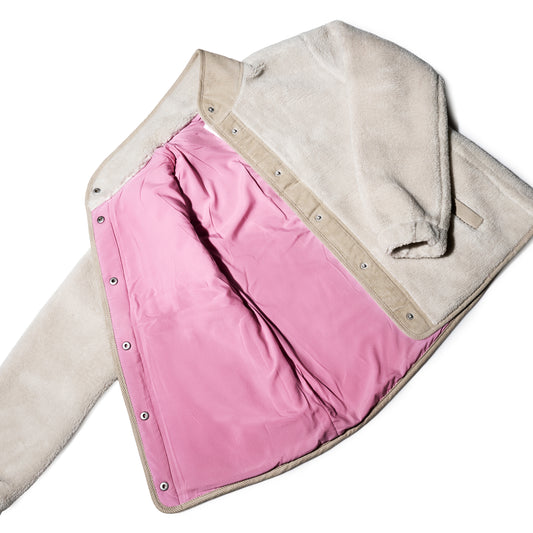 The Fleece Snap-Front Jacket - Moonstruck by Batela USA Inc is laid flat, revealing a pink lining, snap button closures, and a corduroy collar.
