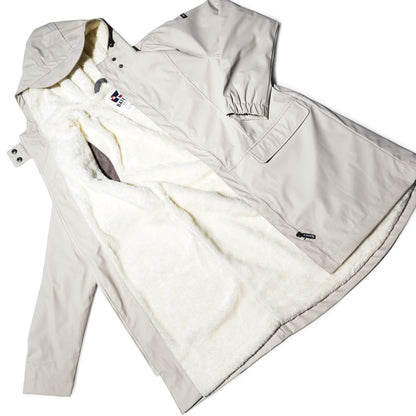The Harborside Waterproof Fleece-Lined Raincoat - Moonstruck by Batela USA Inc features a beige exterior, soft white fleece lining, and front pockets for stylish, year-round comfort.