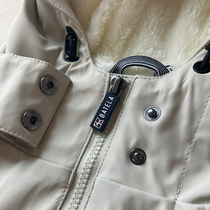 Close-up of the Harborside Waterproof Fleece-Lined Raincoat - Moonstruck by Batela USA Inc, showing snap buttons, zipper, black drawstrings, and plush white fleece lining.