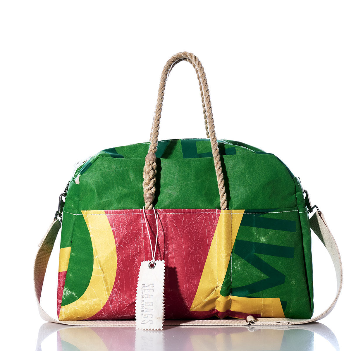 Introducing the Sea Bags Vintage Multicolor Weekender—a vibrant, retro-inspired bag with green, red, and yellow panels. It features sturdy hemp rope handles, a detachable white shoulder strap, and a signature white SEABAGS tag. Perfectly blending eye-catching design with everyday function, this getaway essential by Sea Bags is ready for your next adventure. by Sea Bags