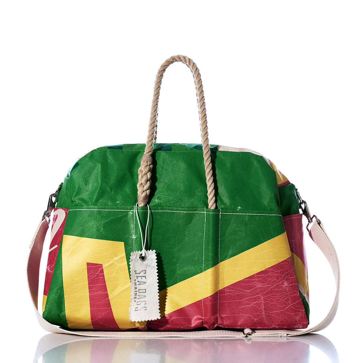 The Sea Bags Vintage Multicolor Weekender features vibrant green, red, and yellow geometric patterns, sturdy hemp handles, and a white shoulder strap. A white SEABAGS tag is attached to one handle—making it the perfect choice for your next getaway. by Sea Bags