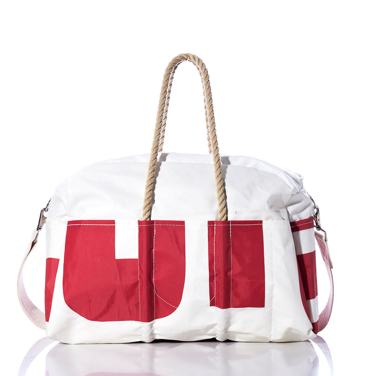 The Sea Bags Vintage Red and White Weekender features vintage-inspired red and white block lettering, sturdy rope handles, and a detachable shoulder strap. Photographed on a white background, it’s the perfect bag for your next getaway. by Sea Bags