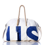 Introducing the Vintage US Weekender by Sea Bags—a vintage-inspired white duffle bag featuring blue lettering, sturdy rope handles, a beige shoulder strap, and a signature Sea Bags tag. It’s the perfect go-to weekender bag for any getaway. by Sea Bags