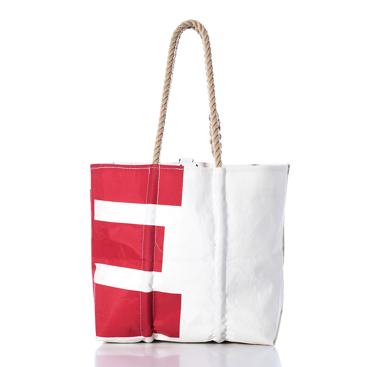 The Sea Bags Vintage UE Medium Tote features a white sailcloth body with red rectangular patterns, rope handles, and a wrinkled texture reminiscent of handcrafted Maine designs, shown against a plain white background. by Sea Bags