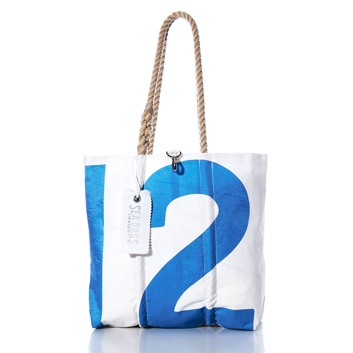 The Sea Bags Vintage 12 Medium Tote features a crisp white background, a bold blue number 12 print, hand-spliced rope handles, and a signature SEABAGS tag near the top—capturing the classic Maine-crafted charm of this iconic sail tote. by Sea Bags