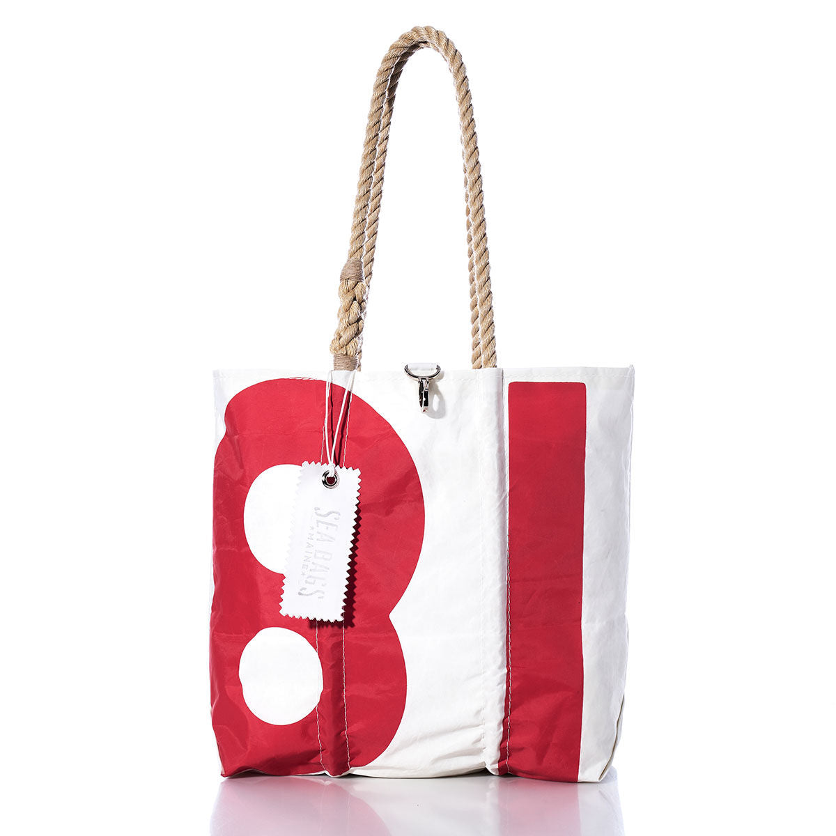 The Sea Bags Vintage 81 Medium Tote, featuring white and red coloring, rope handles, and a tag attached, is photographed on a white background. by Sea Bags
