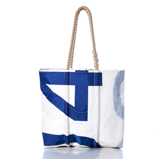 The Sea Bags Vintage 904 Medium Tote, a white and blue sailcloth bag with rope handles, is handmade in Maine from recycled sailcloth and displayed on a white background. by Sea Bags