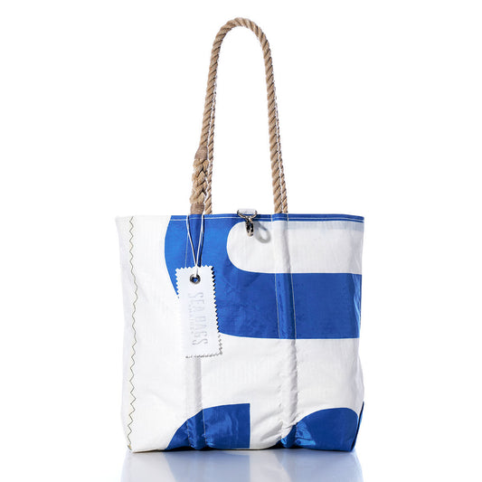 The Sea Bags Vintage USA Medium Tote features large, bold blue shapes on a white background, hand-spliced rope handles, a rectangular tag, and visible stitching—drawing inspiration from Maines tradition of handcrafted bags. by Sea Bags