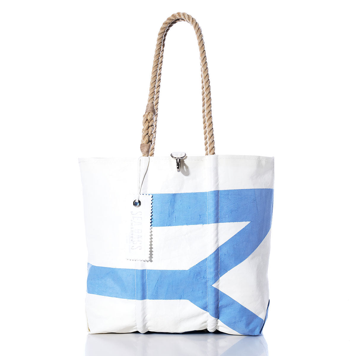 Sea Bags Vintage Morris Medium Tote featuring a large blue abstract design on white sailcloth, accented with rope handles and a white tag, handcrafted in Maine and photographed on a white background. by Sea Bags
