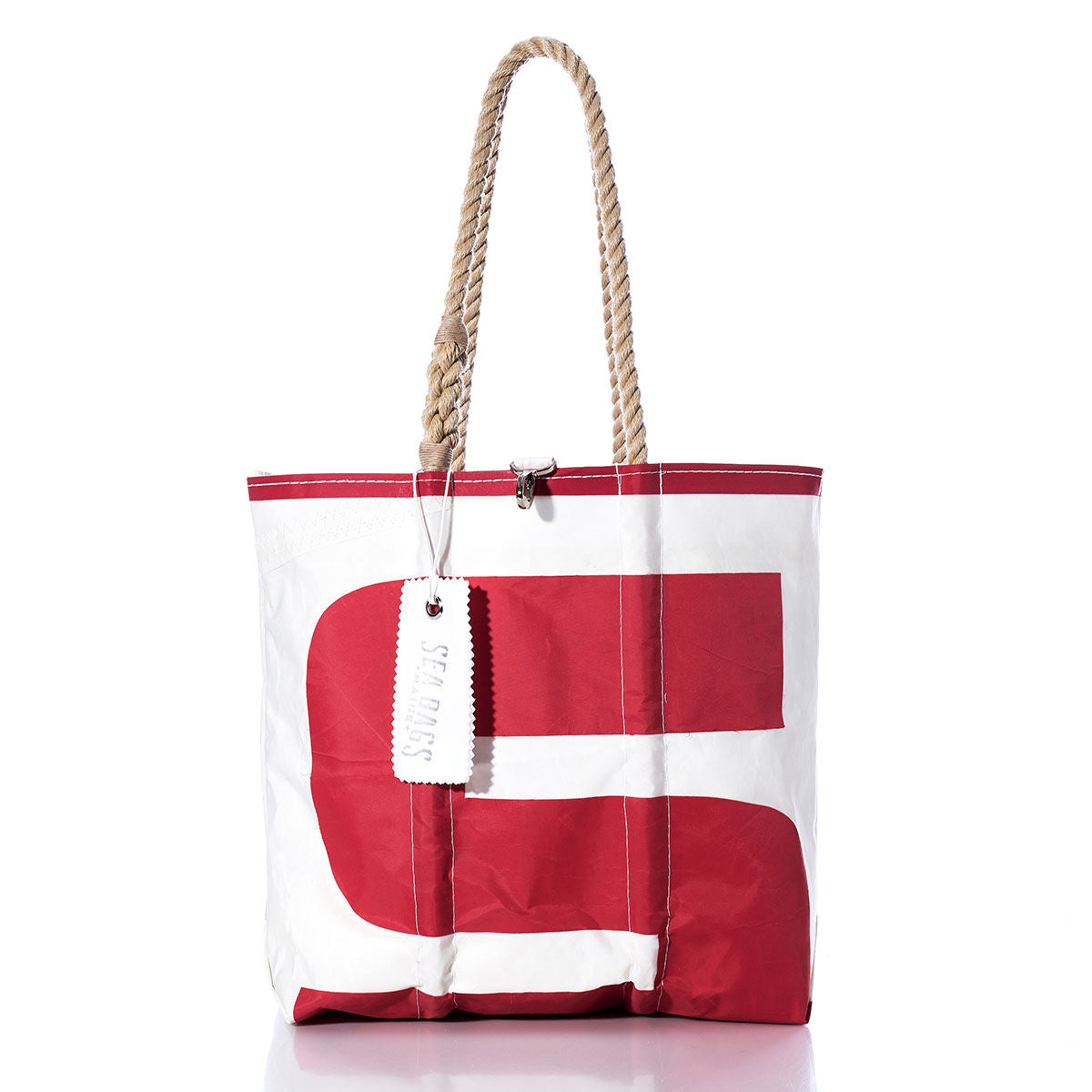 The Sea Bags Vintage S8 Medium Tote features a red graphic design on white sailcloth, hand-spliced rope handles, and a white SEABAGS tag attached near the top. This tote showcases an original sail insignia for a distinctive nautical touch. by Sea Bags