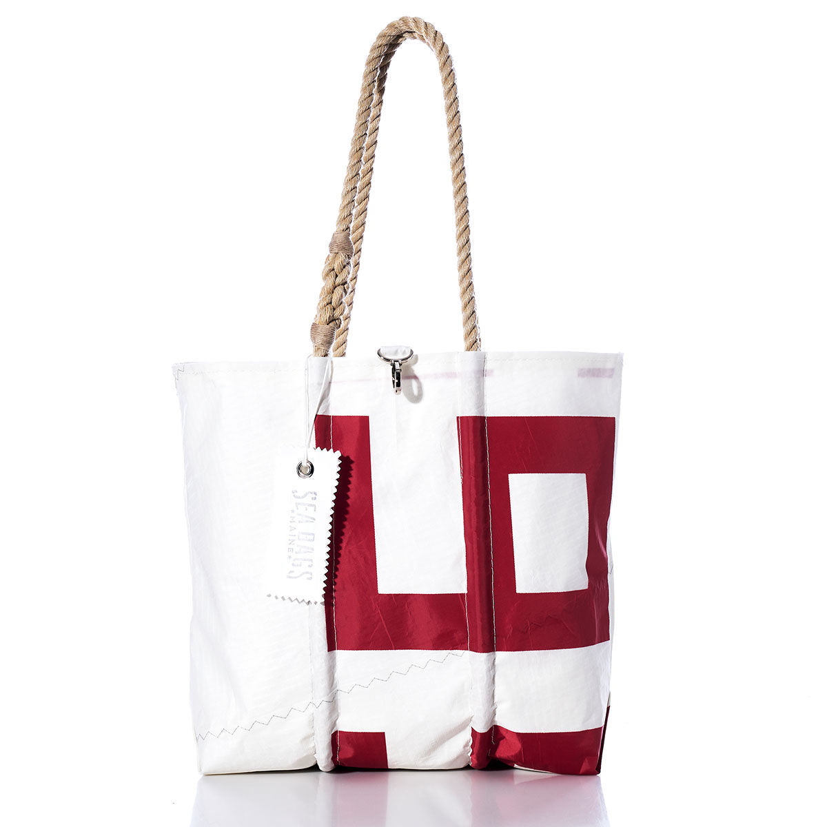 The Sea Bags Vintage 997 Medium Tote, made from white sailcloth with red block lettering, features hand-spliced rope handles and a white tag that reads Sails. This vintage tote is shown against a white background. by Sea Bags