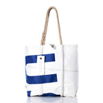 Sea Bags’ Vintage USA Medium Tote, featuring white and blue sailcloth, hand-spliced rope handles, zigzag stitching, and a rectangular tag, is displayed on a white background. by Sea Bags