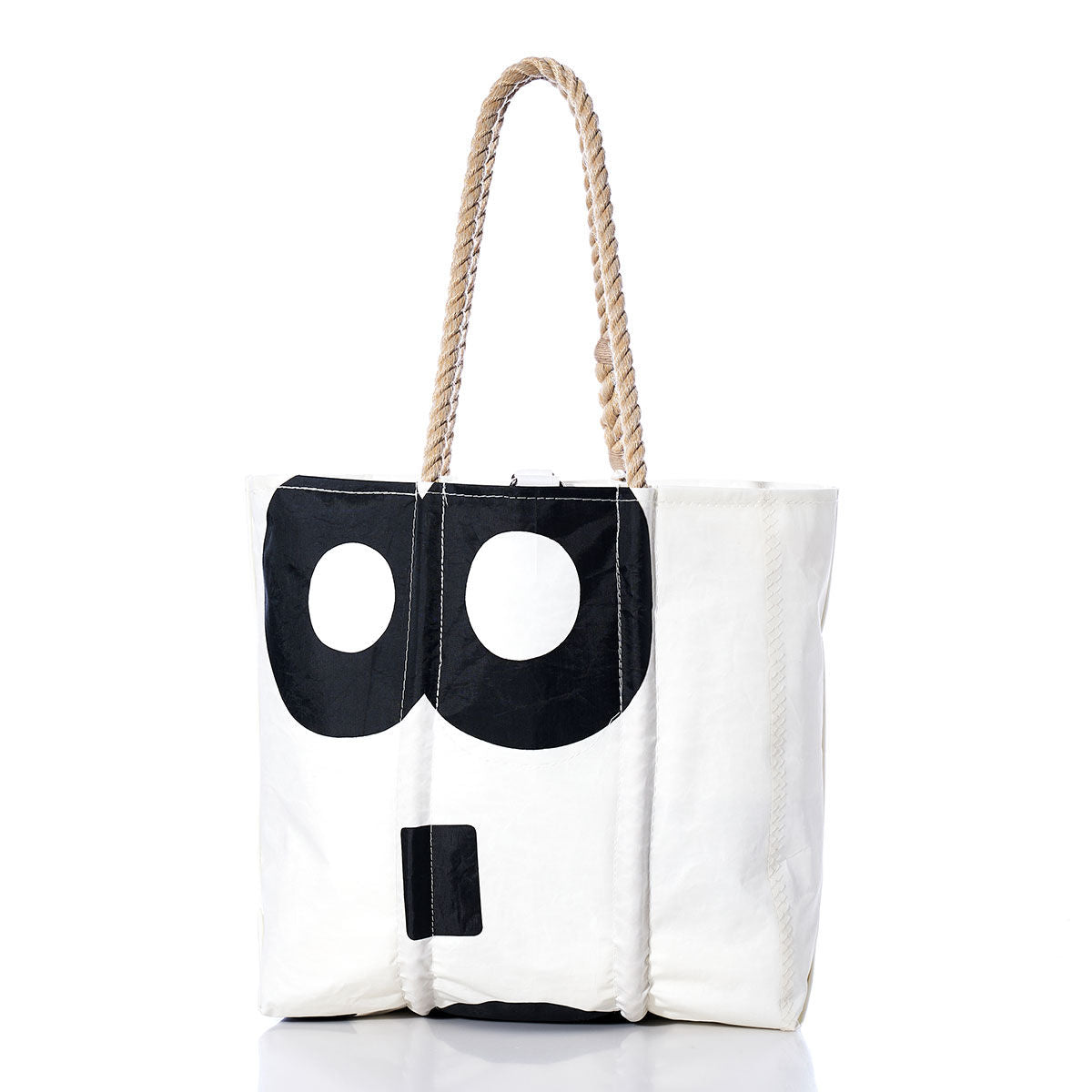 The Sea Bags Vintage US-8 Medium Tote is a white tote bag featuring hand-spliced rope handles and a striking black graphic design reminiscent of abstract eyes and a nose on one side, photographed against a white background. Expertly crafted in Maine, this bag captures the essence of a vintage sail tote with its robust construction and distinctive maritime-inspired accents. by Sea Bags