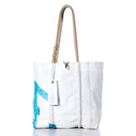 Handcrafted in Maine from recycled sailcloth, the Sea Bags Vintage 470 Medium Tote features a blue design, sturdy rope handles, distinctive zigzag stitching, and an authentic Sea Bags tag. This stylish tote is both sustainable and unique. by Sea Bags