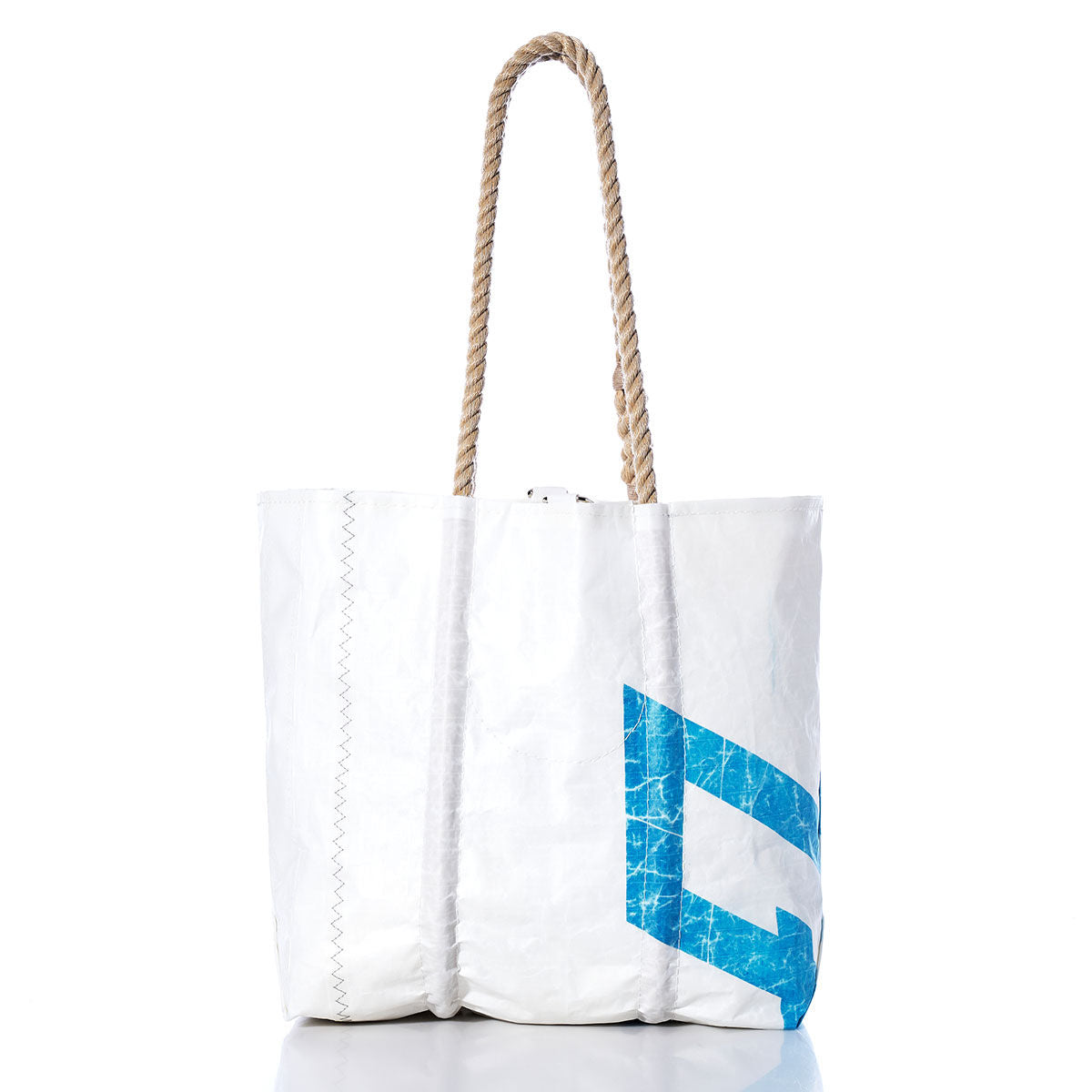 The Sea Bags Vintage 470 Medium Tote is a white sailcloth bag featuring rope handles and a blue geometric design, handmade in Maine. Photographed on a white background, this tote exudes coastal charm and durability. by Sea Bags