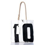Sea Bags Vintage 10 Medium Tote features hand-spliced rope handles, a large black number 10 on the front, and a white rectangular tag. Meticulously crafted in Maine from vintage sailcloth, this tote blends durability with timeless coastal style. by Sea Bags