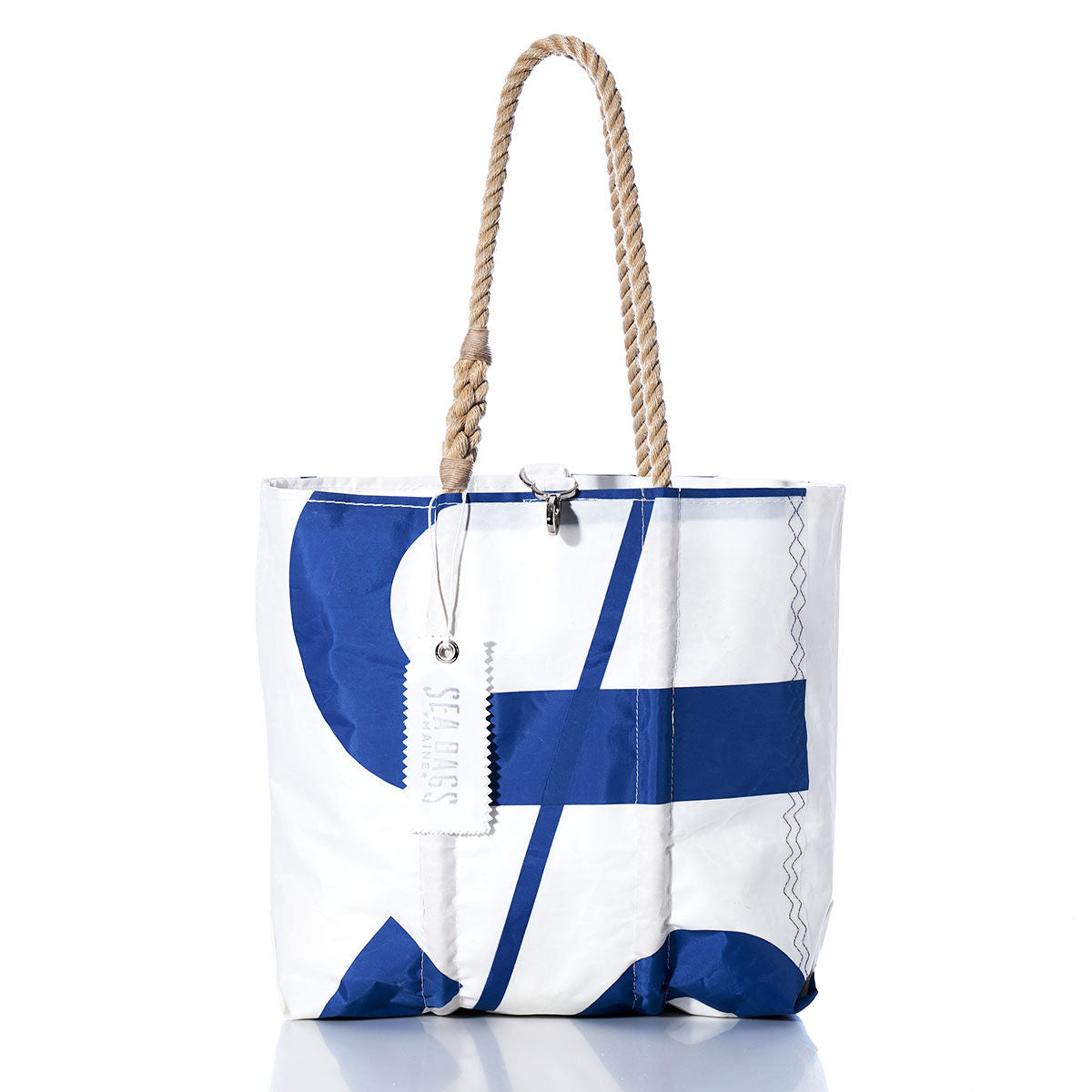 The Sea Bags Vintage USA Medium Tote, featuring a white and blue sailcloth design with rope handles and an attached white tag, crafted in the style of a handcrafted Maine tote, is photographed against a white background. by Sea Bags