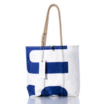 A white Vintage USA Medium Tote by Sea Bags, featuring bold blue letters, rope handles, and crafted from durable sailcloth with a tag labeled SHIPS, is displayed against a white background. by Sea Bags