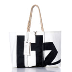 Introducing the Vintage Black 41 Large Tote by Sea Bags—a sailcloth bag featuring a bold black graphic print, braided rope handles, and a white Sea Bags tag near the top. Handmade in Maine for exceptional style and lasting durability. by Sea Bags