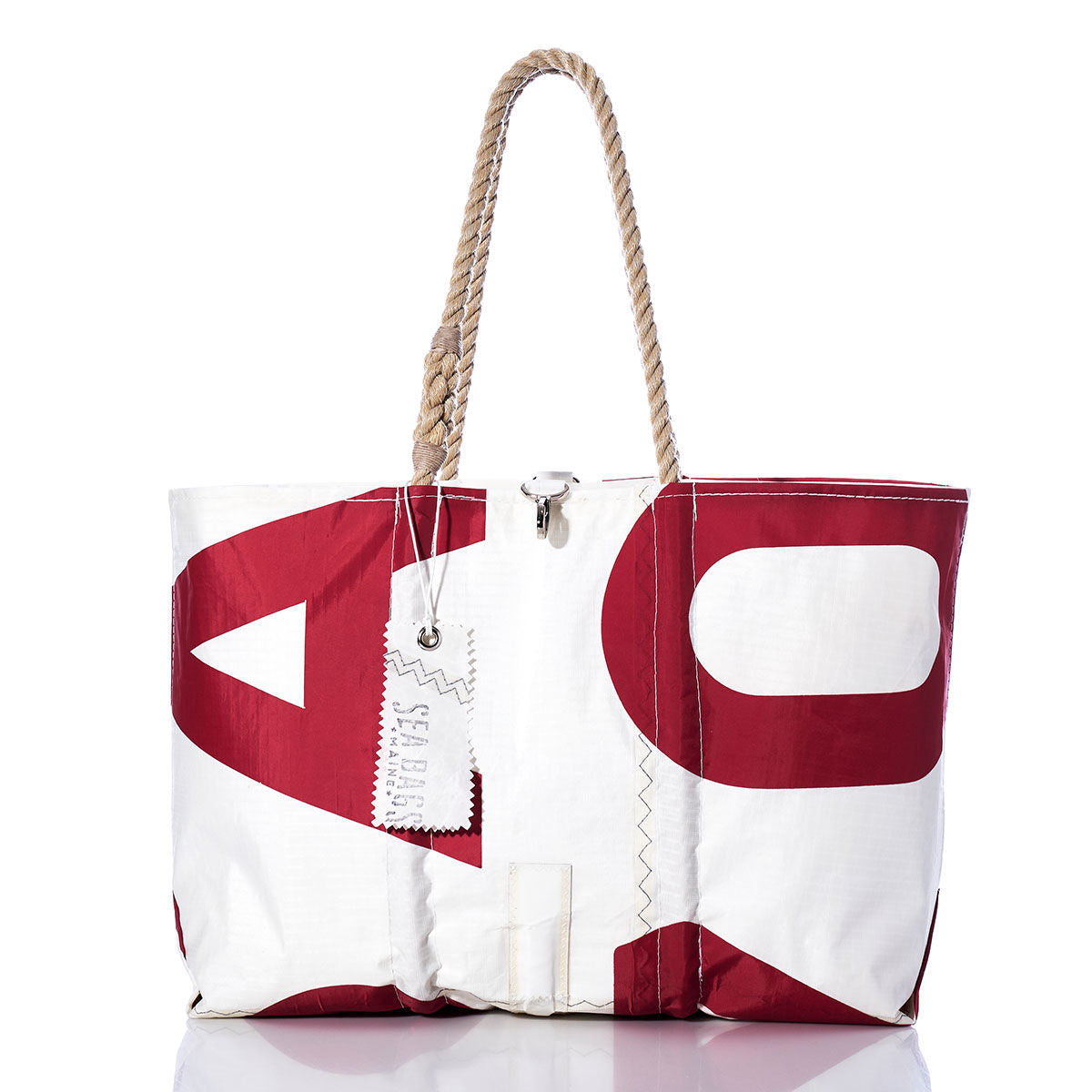 The Sea Bags Vintage USA770 Large Tote features hand-spliced rope handles, a striking red graphic print, and a distinctive SEA BAGS label. Crafted in Maine to echo the classic appeal of vintage sail totes, this white and red bag is photographed on a clean white background. by Sea Bags