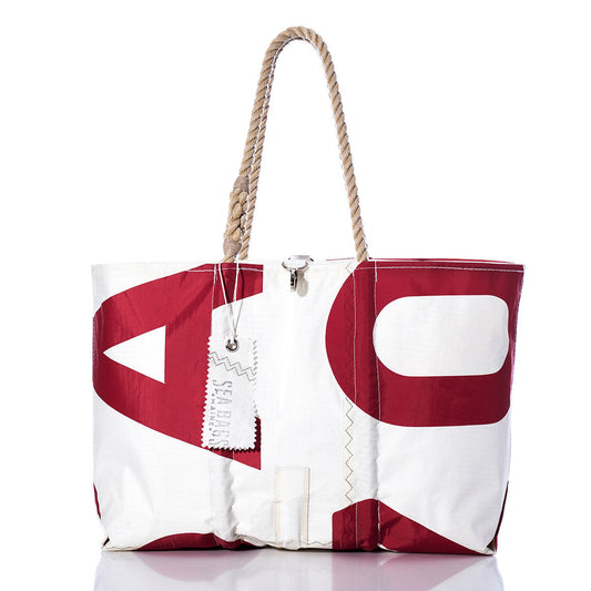 The Sea Bags Vintage USA770 Large Tote features hand-spliced rope handles, a striking red graphic print, and a distinctive SEA BAGS label. Crafted in Maine to echo the classic appeal of vintage sail totes, this white and red bag is photographed on a clean white background. by Sea Bags