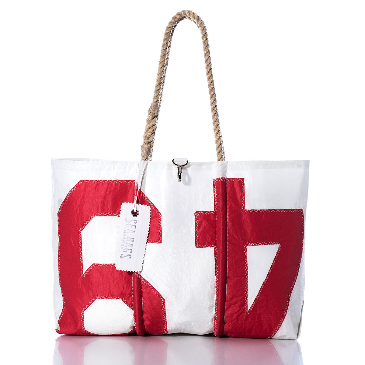Sea Bags Vintage 49 Large Tote—a white sail tote featuring bold red numbers 6 and 7, hand-spliced rope handles, and a white tag on one handle, displayed against a white background; inspired by Maine-crafted vintage designs. by Sea Bags