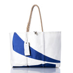 White tote bag featuring a blue wave design, tan rope handles, and a white tag labeled Sea Bags, displayed on a white background. The Vintage Etchells Large Tote by Sea Bags is handmade in Maine from sailcloth, blending nautical style with durable craftsmanship. by Sea Bags