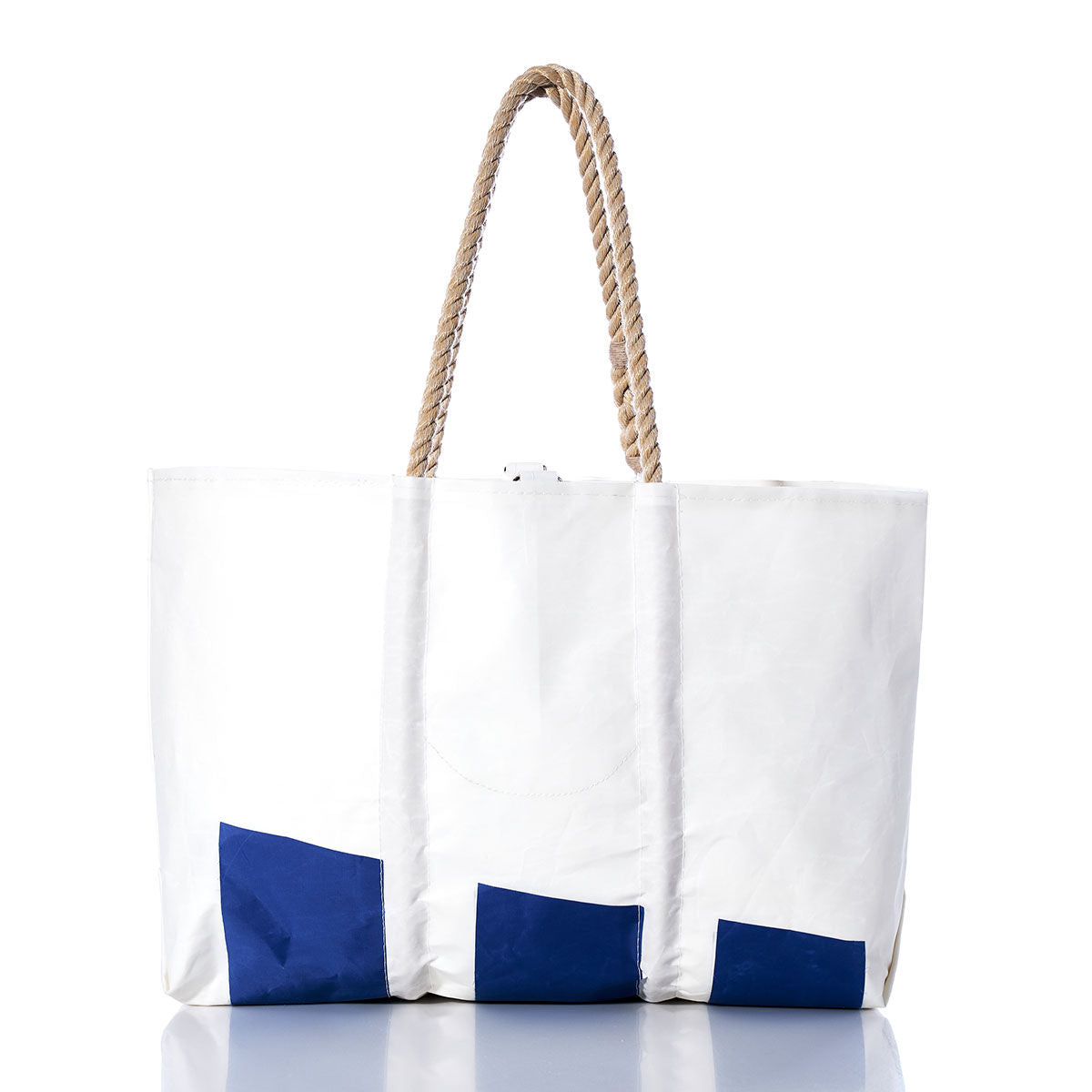 Sea Bags Vintage Etchells Large Tote: A white tote bag featuring blue geometric accents and two twisted rope handles, handcrafted in Maine from durable sailcloth, displayed on a white background with a subtle reflection. by Sea Bags
