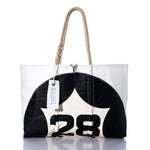 The Vintage 28 Large Tote by Sea Bags is a handmade Maine bag crafted from white and black sailcloth, featuring the number 28, sturdy rope handles, and a signature Sea Bags tag. Photographed against a white background, this tote showcases classic style paired with durable craftsmanship. by Sea Bags