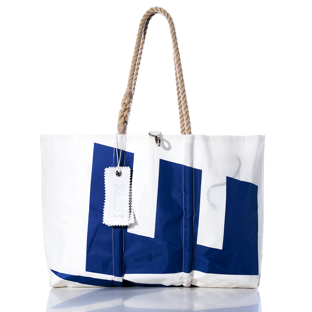 Sea Bags Vintage Etchells Large Tote—a white and blue handmade Maine bag featuring a geometric pattern, sturdy rope handles, and a white tag, beautifully displayed against a plain white background. by Sea Bags