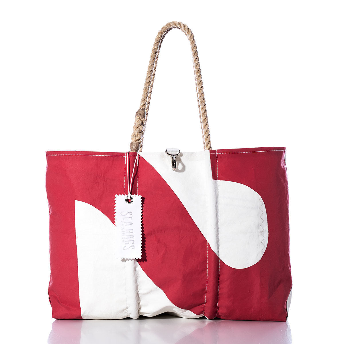 Introducing the Sea Bags Vintage 27 Large Tote—a red and white handmade Maine tote, crafted from durable sailcloth with sturdy rope handles, a metal clasp, and a branded Sea Bags tag, displayed against a white background. by Sea Bags